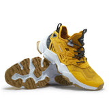 Yellow hiking shoe with brown sole on a white background, featuring 