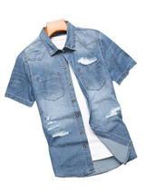 Men's summer blue short - sleeved denim shirt with ripped details. The ripped design elements showcase a trendy and casual style