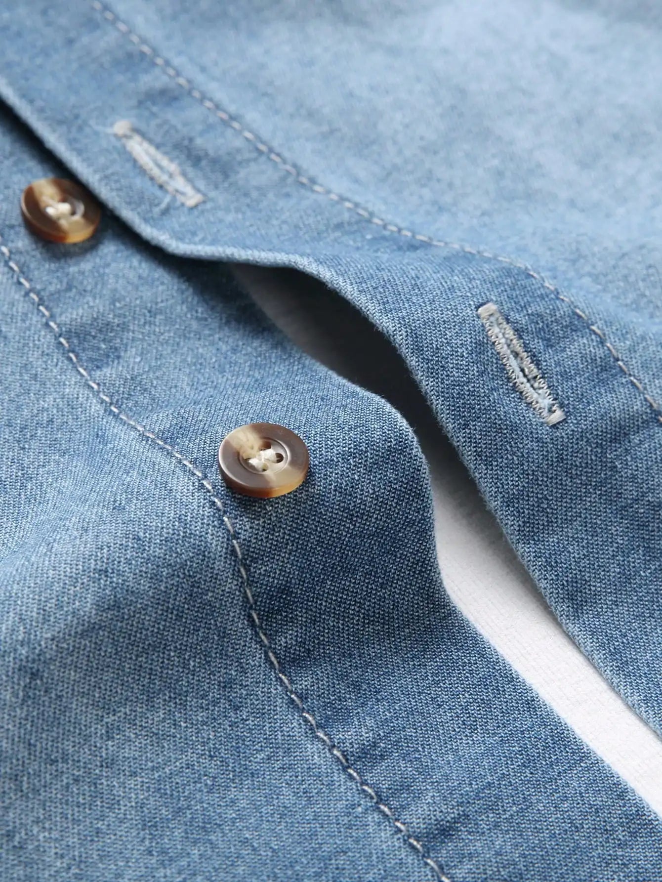 Men's summer blue short - sleeved denim shirt with ripped details. The ripped design elements showcase a trendy and casual style